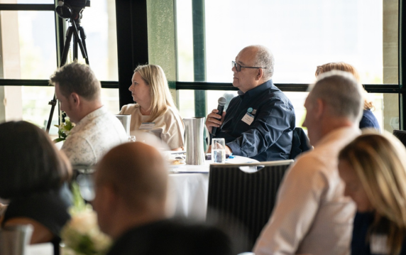 Attendees sitting at a forum.