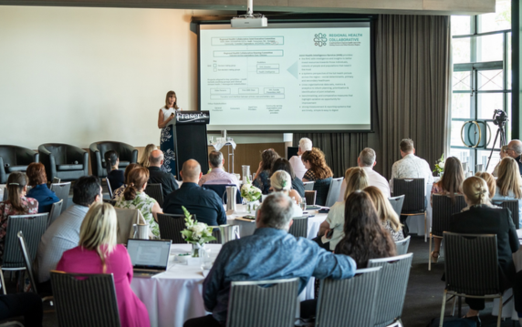Attendees sitting at a forum.