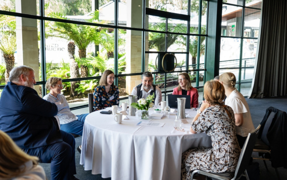 Attendees sitting at a forum.
